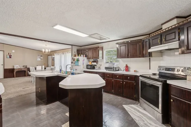 a kitchen with a sink stainless steel appliances and cabinets