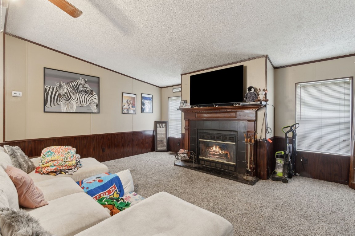2889 Santa Fe Trail Hilliard, FL 32046 - Photo 39 of 49 a living room with furniture a flat screen tv and a fireplace