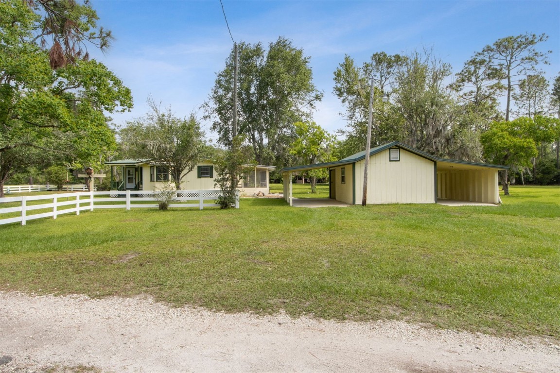 2889 Santa Fe Trail Hilliard, FL 32046 - Photo 43 of 49 a view of a house with a yard