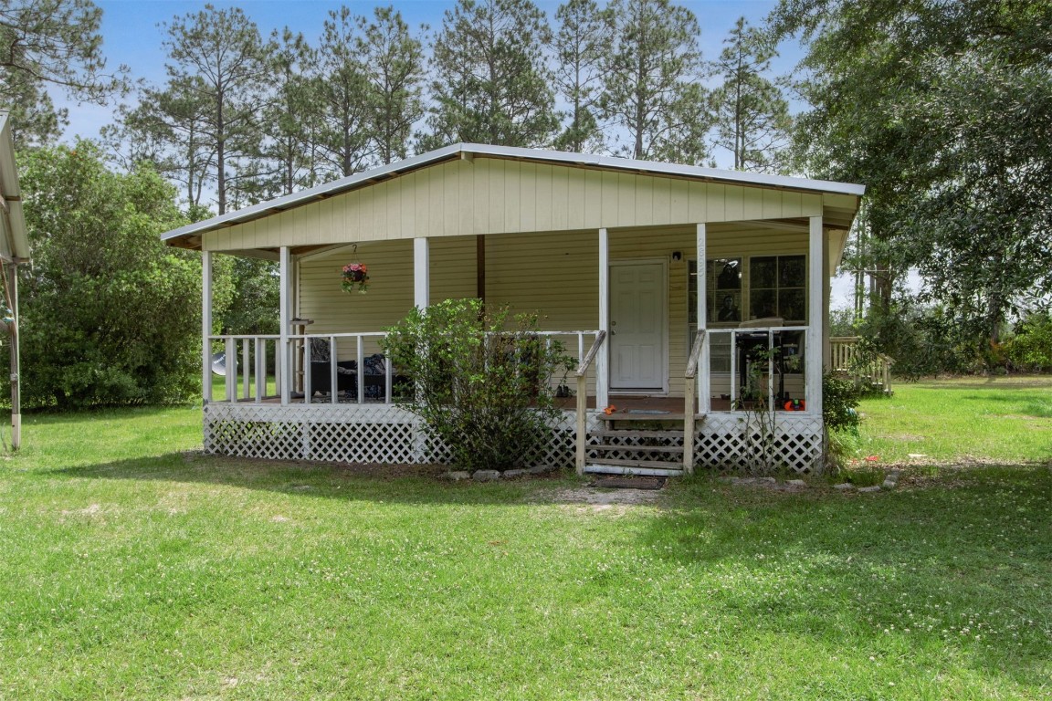 2889 Santa Fe Trail Hilliard, FL 32046 - Photo 5 of 49 a front view of a house with a garden