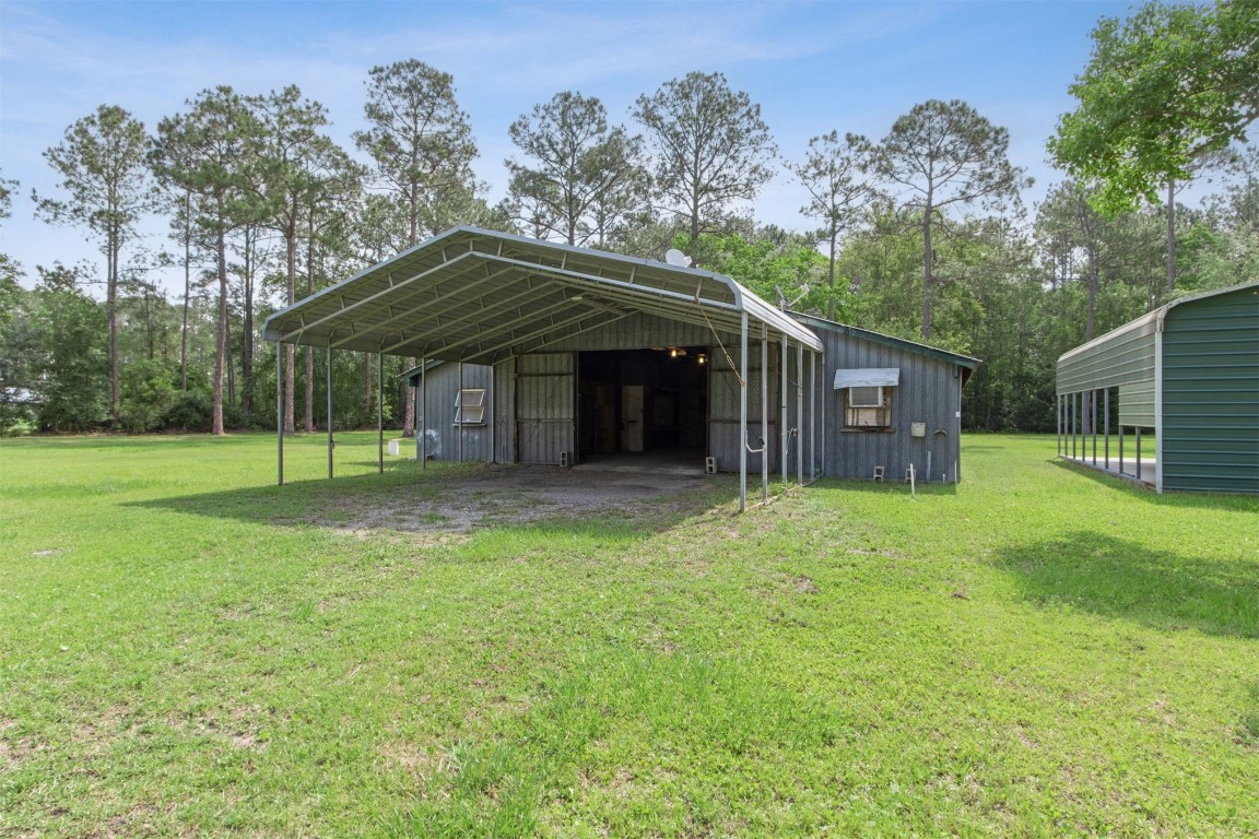 2889 Santa Fe Trail Hilliard, FL 32046 - Photo 6 of 49 a view of a house with backyard and a tree