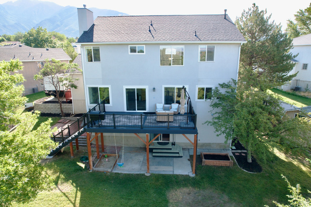 11882 Pond Ridge Drive Draper, UT 84020 - Photo 48 of 49 Rear elevation with a multi-level deck, mountain backdrop, and ground-level patio