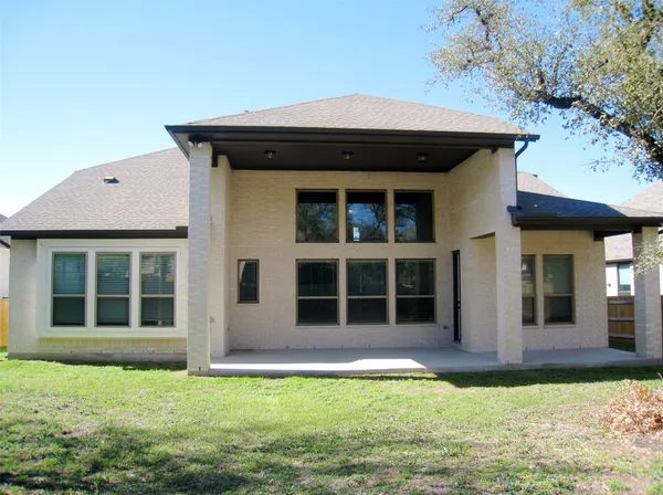 a view of a house with yard and sitting area