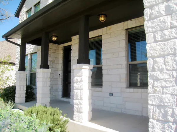 a front view of a house with a potted plant and garage