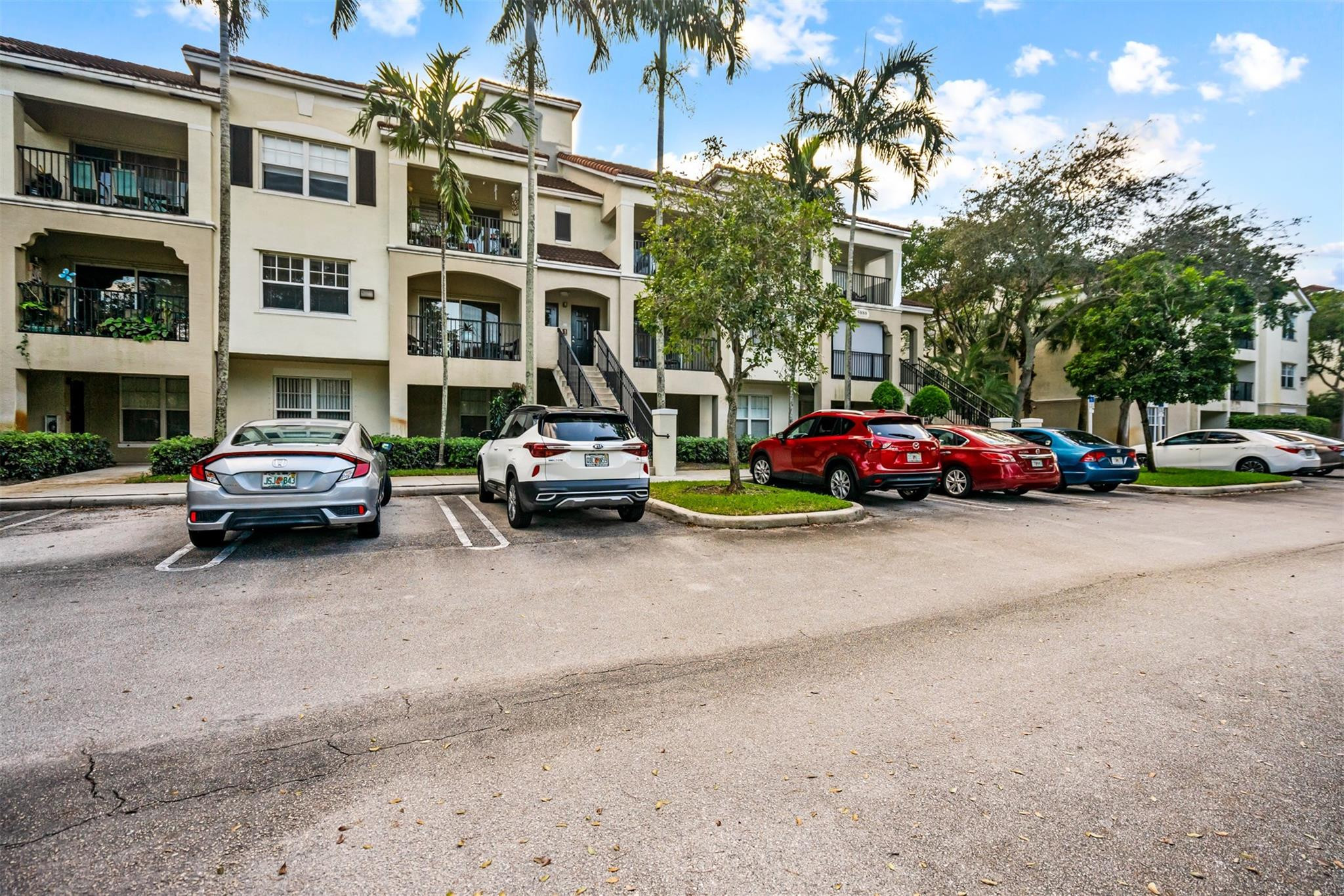 5880 West Sample Road, Unit 307 Coral Springs, FL 33067 - Photo 12 of 25 a car parked in front of a building