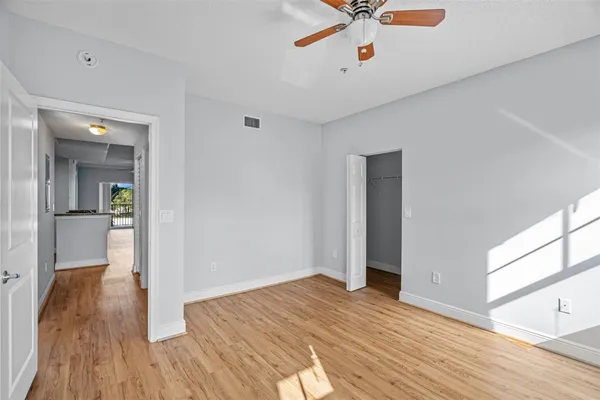 a view of empty room with wooden floor