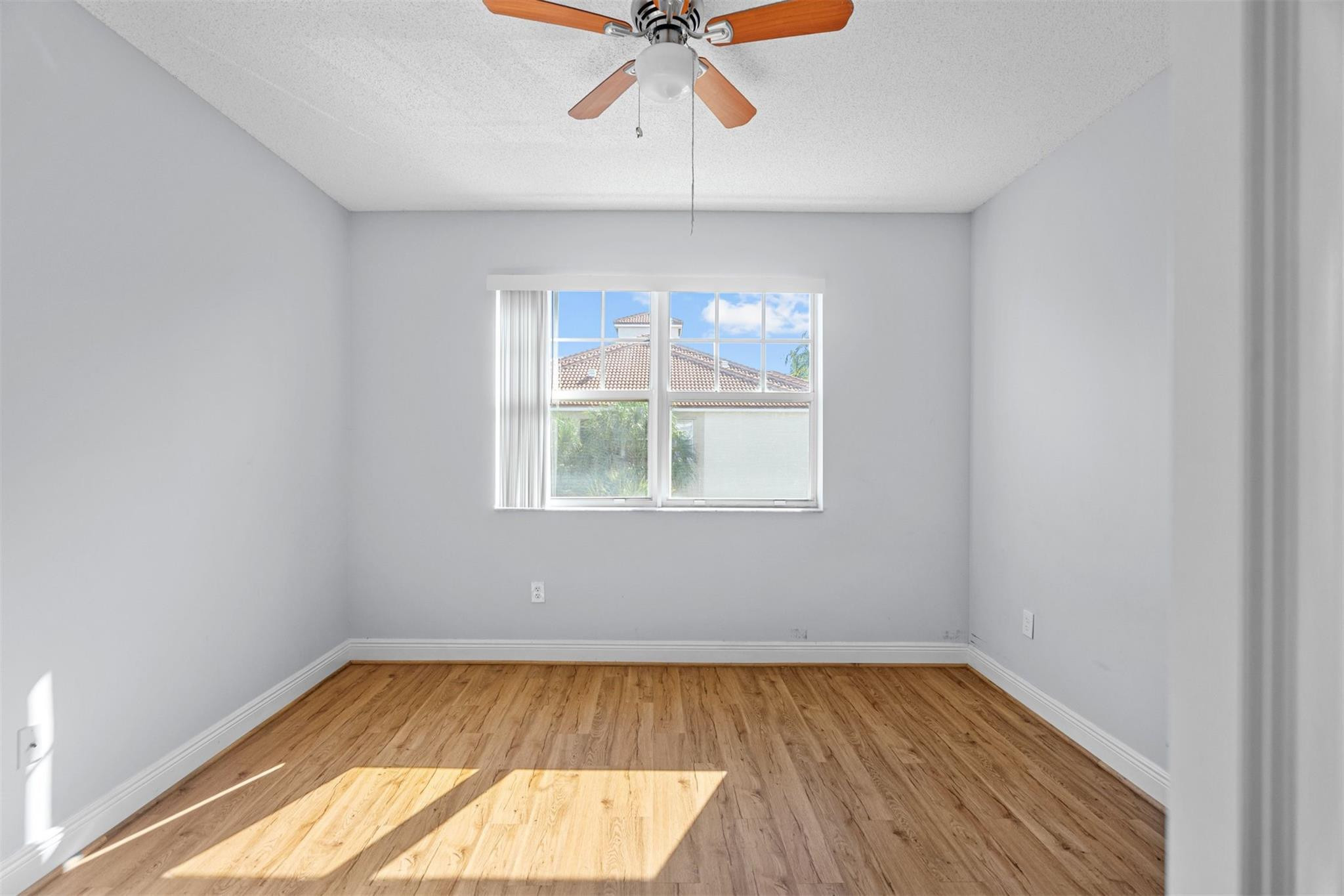 5880 West Sample Road, Unit 307 Coral Springs, FL 33067 - Photo 16 of 25 an empty room with a window