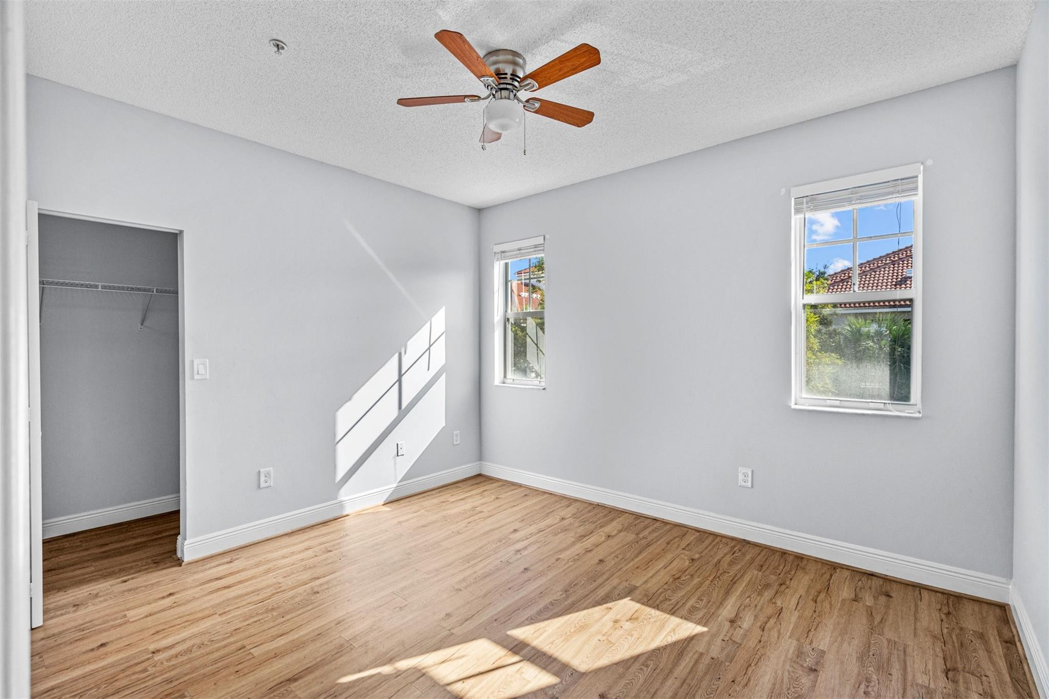 5880 West Sample Road, Unit 307 Coral Springs, FL 33067 - Photo 17 of 25 wooden floor in an empty room with a window