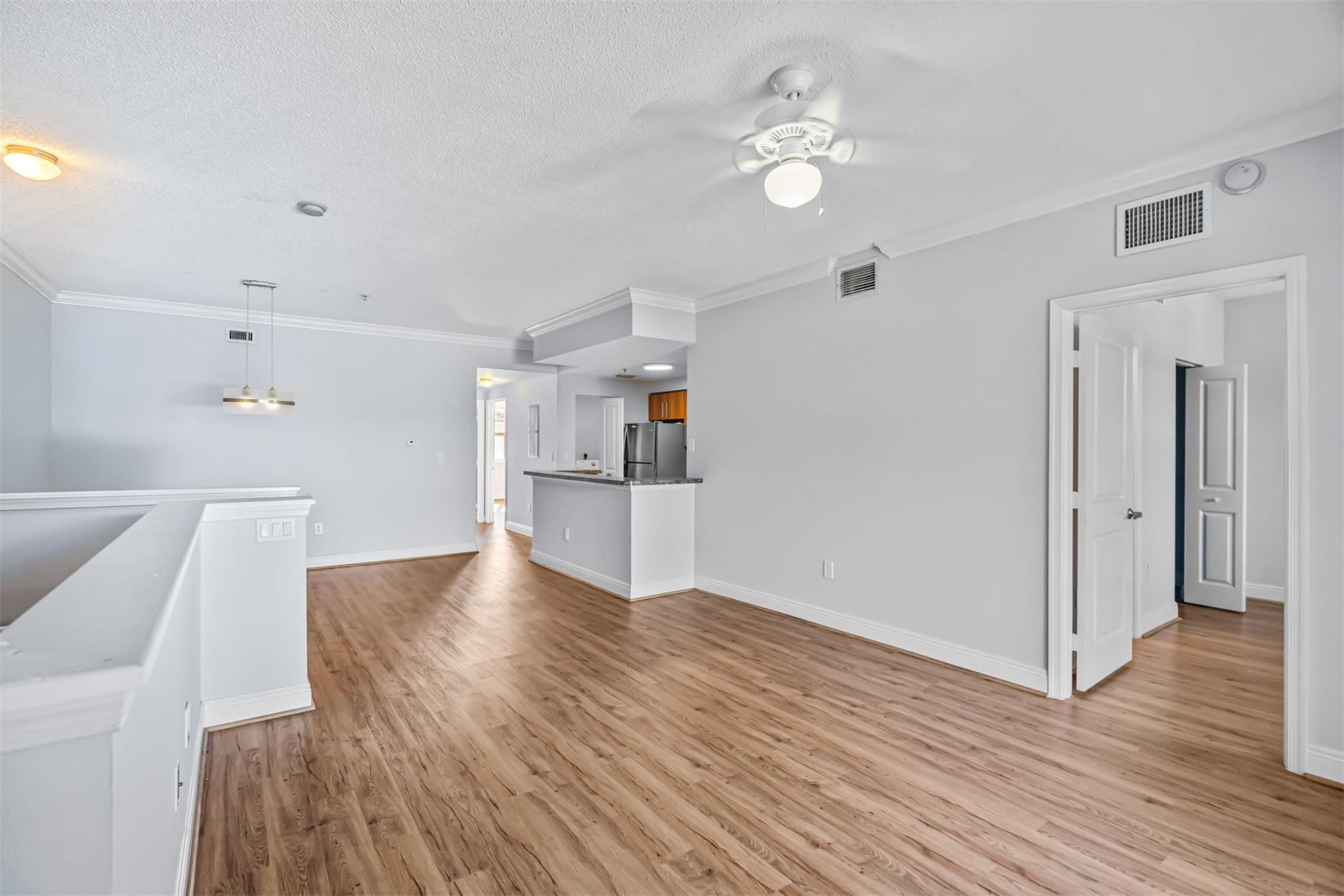 5880 West Sample Road, Unit 307 Coral Springs, FL 33067 - Photo 5 of 25 a view of empty room with wooden floor