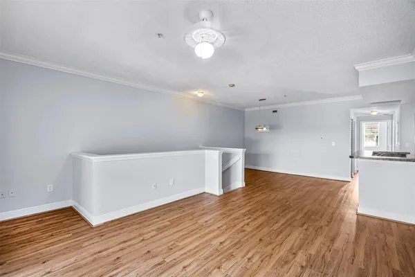 a view of empty room with wooden floor