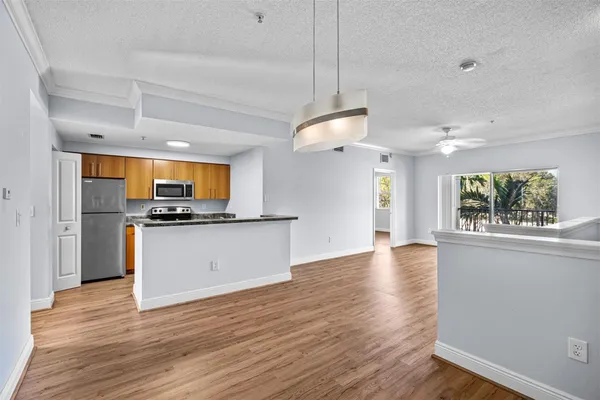 a view of kitchen with sink and wooden floor