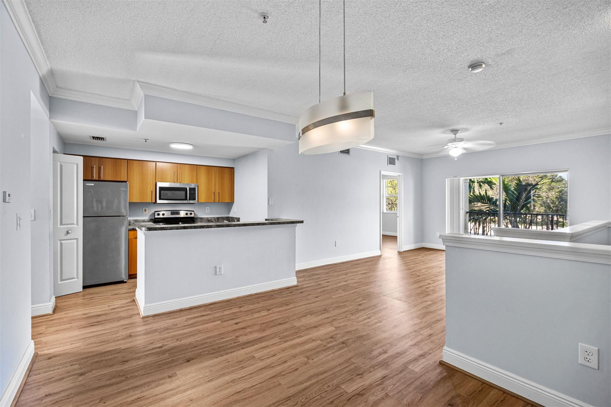 5880 West Sample Road, Unit 307 Coral Springs, FL 33067 - Photo 8 of 25 a view of kitchen with sink and wooden floor