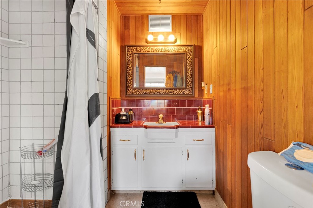 14415 Erie Road Apple Valley, CA 92307 - Photo 38 of 61 a bathroom with a sink and a mirror