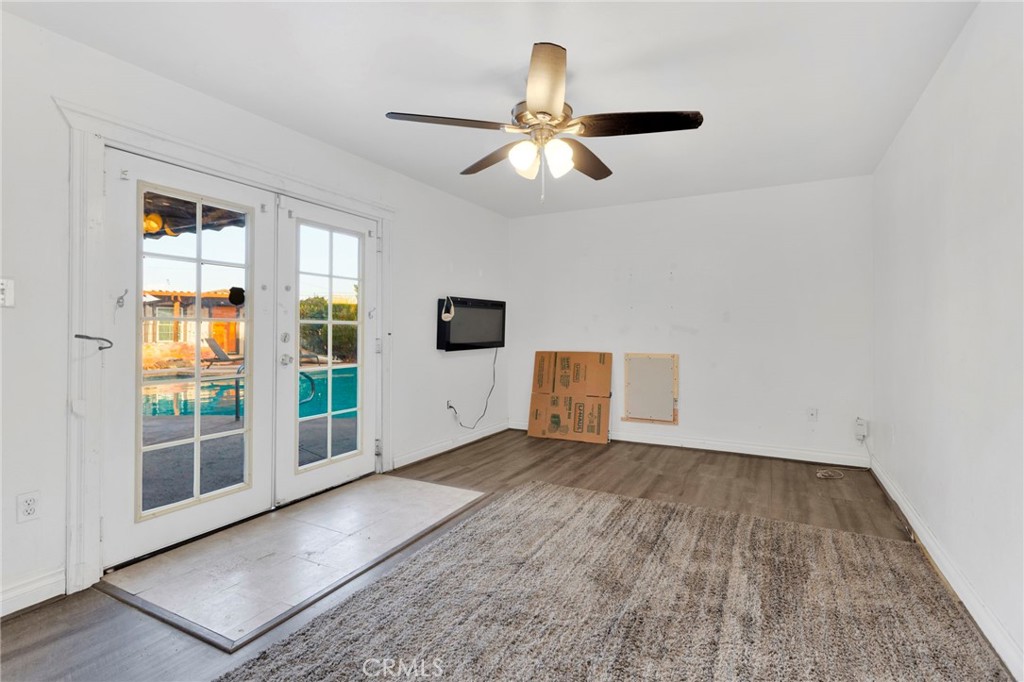 14415 Erie Road Apple Valley, CA 92307 - Photo 41 of 61 an empty room with wooden floor and windows