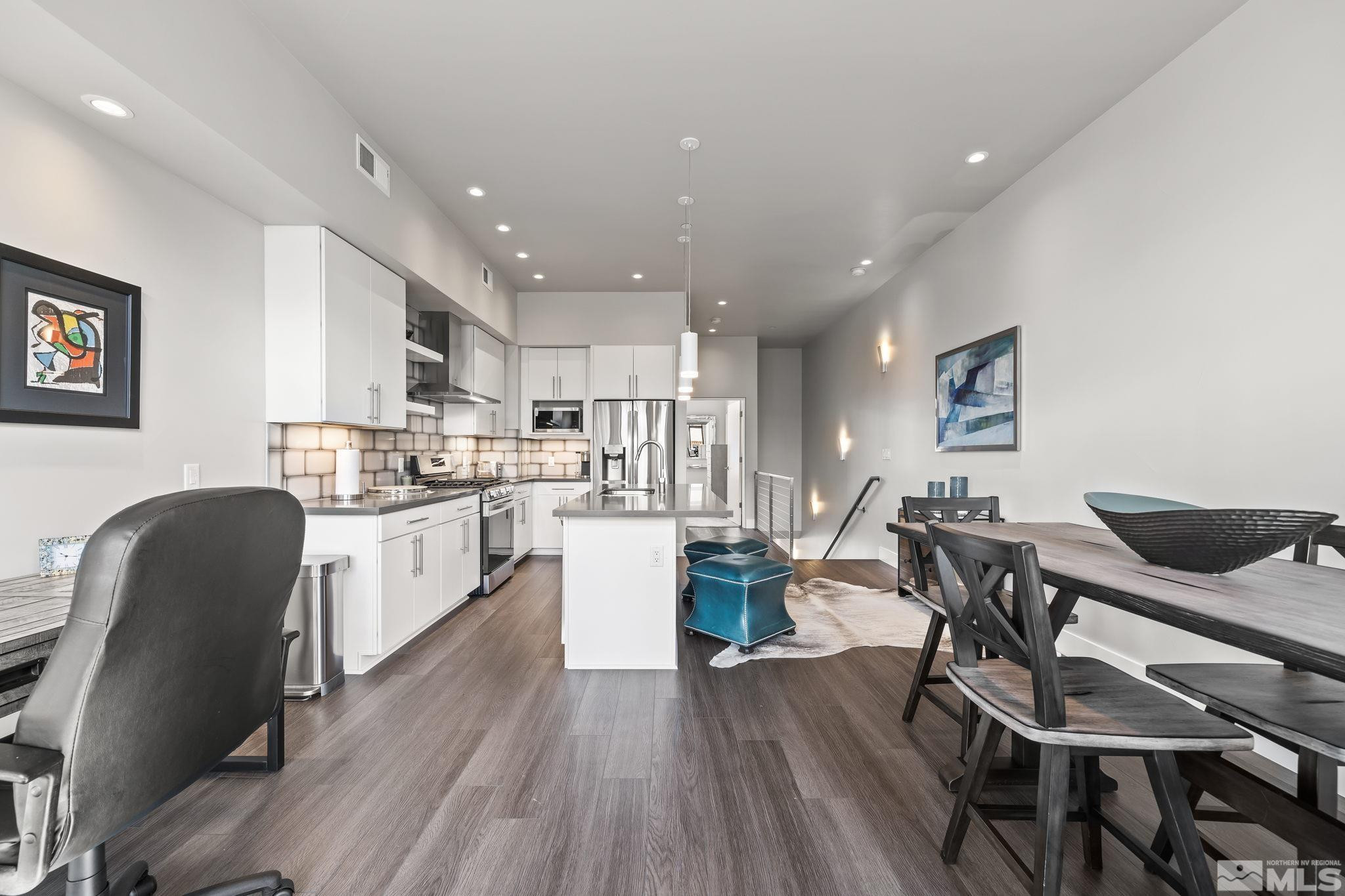 104 High Street Reno, NV 89502 - Photo 11 of 28 a kitchen with a table chairs wooden floors and appliances