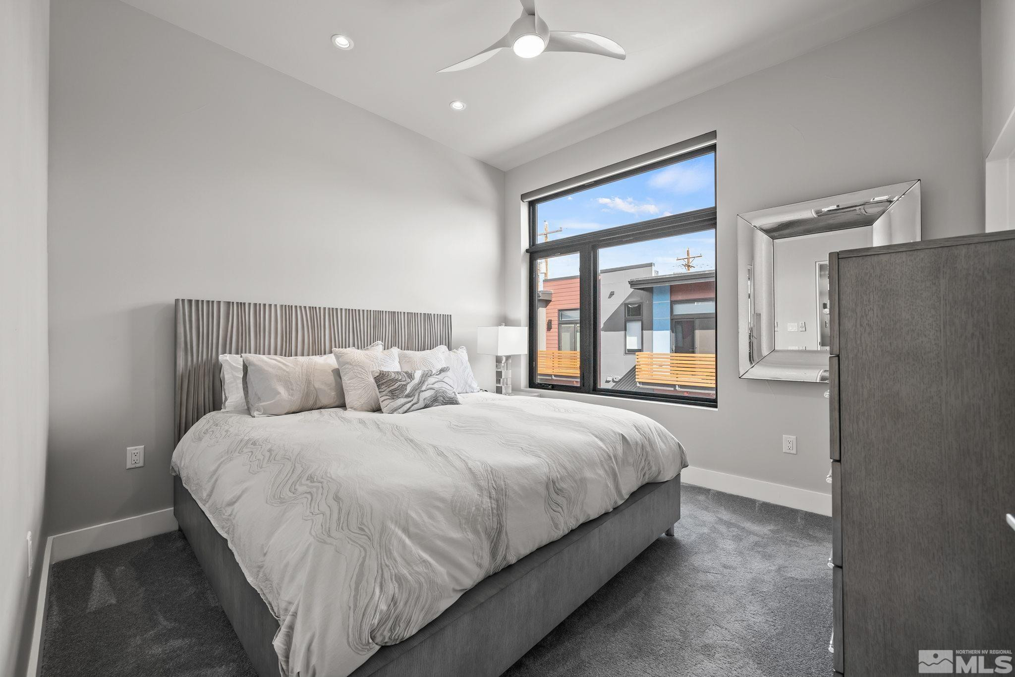 104 High Street Reno, NV 89502 - Photo 17 of 28 a bedroom with a large bed and a large window