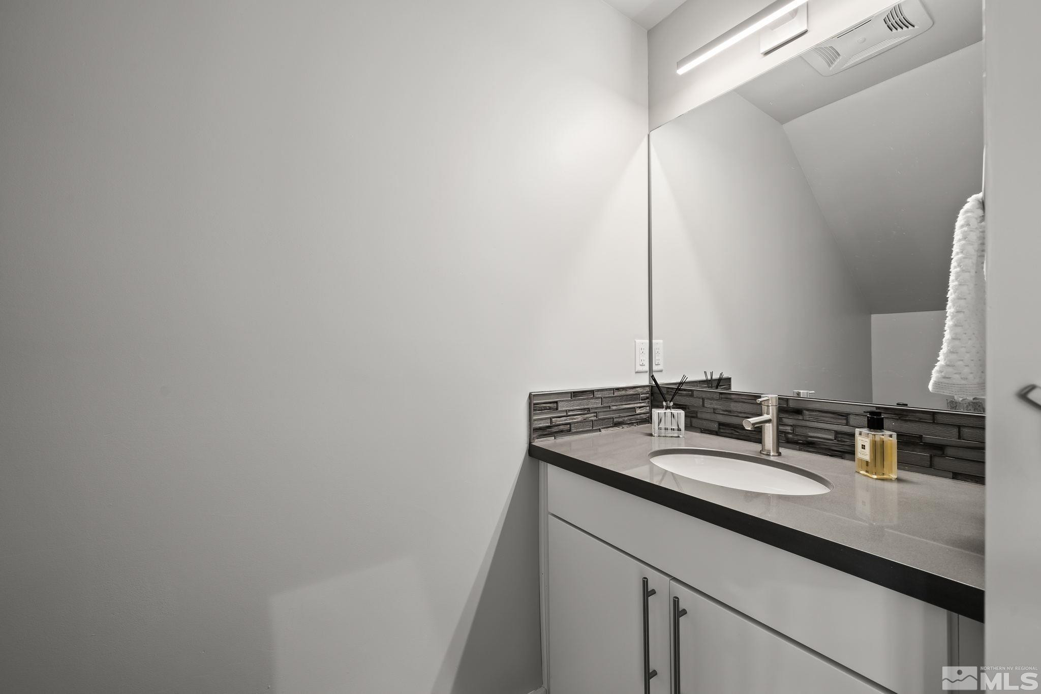 104 High Street Reno, NV 89502 - Photo 21 of 28 a bathroom with a sink and a mirror