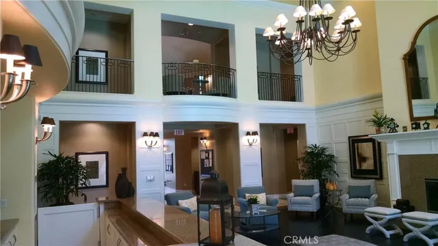 a living room with furniture a fireplace and a potted plant