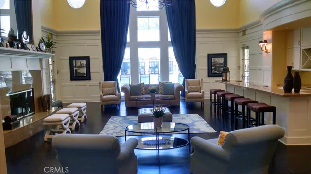 a living room with furniture wooden floor and a large window