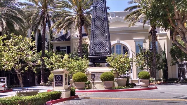 a view of a building with a garden and trees