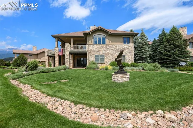 an aerial view of residential houses with outdoor space and trees