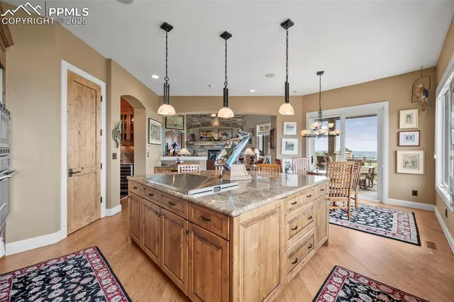 a kitchen with stainless steel appliances granite countertop a sink a counter top space cabinets and a window