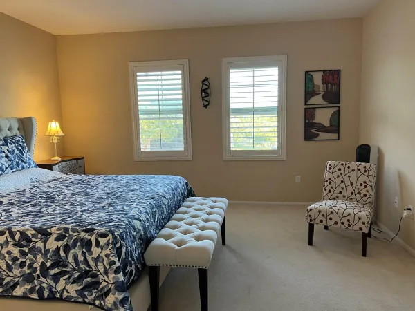 a bedroom with furniture and a window