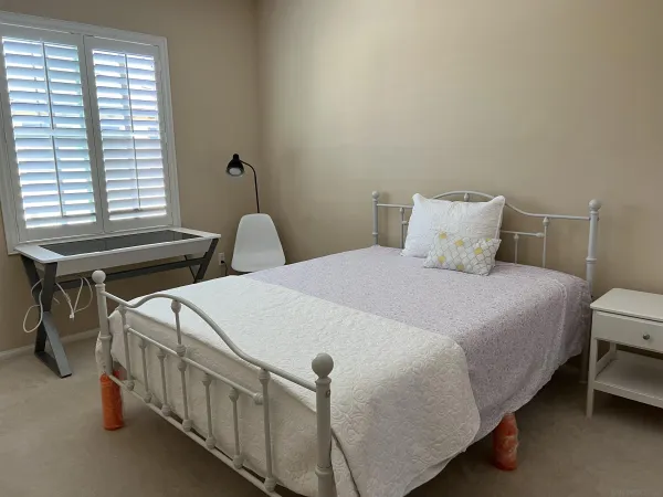 a bedroom with two beds and a window