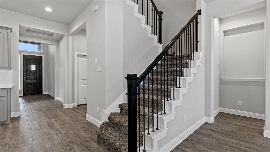 729 Soaring Hawk Drive Aledo, TX 76008 - Photo 10 of 38 a view of a hallway with wooden floor and entryway