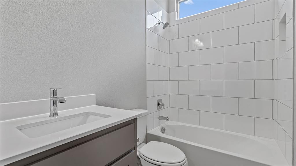 729 Soaring Hawk Drive Aledo, TX 76008 - Photo 19 of 38 a bathroom with a granite countertop bathtub sink vanity mirror and toilet
