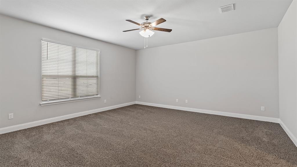 729 Soaring Hawk Drive Aledo, TX 76008 - Photo 21 of 38 an empty room with chandelier fan and windows