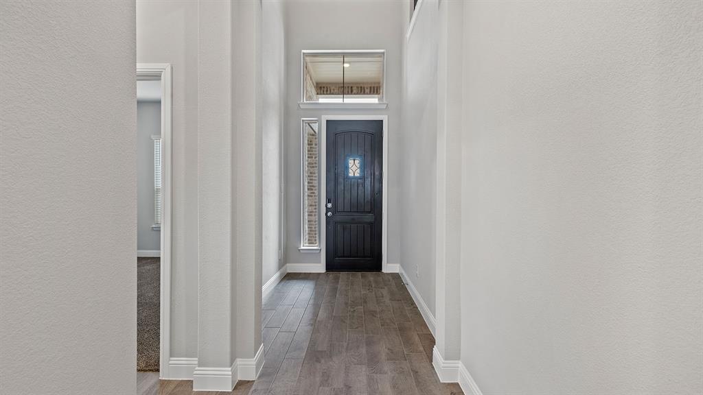 729 Soaring Hawk Drive Aledo, TX 76008 - Photo 32 of 38 a view of a hallway with wooden floor