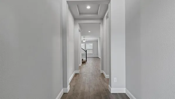 a view of a hallway with wooden floor
