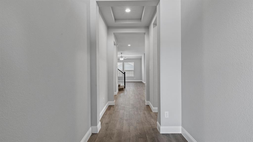 729 Soaring Hawk Drive Aledo, TX 76008 - Photo 33 of 38 a view of a hallway with wooden floor