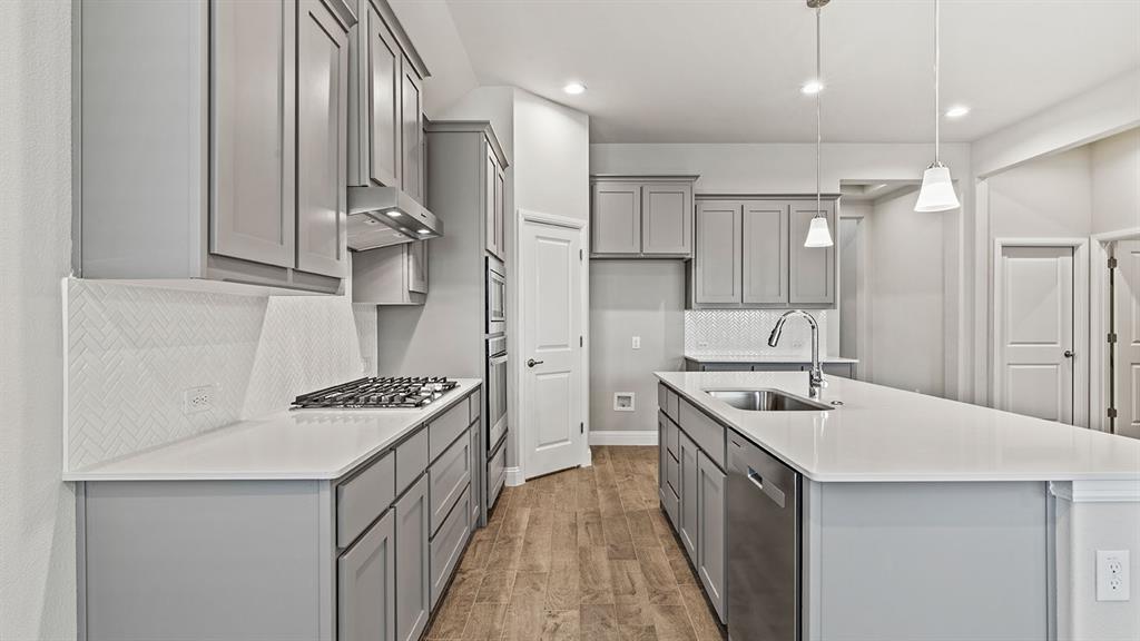 729 Soaring Hawk Drive Aledo, TX 76008 - Photo 2 of 38 a kitchen with a stove and a sink