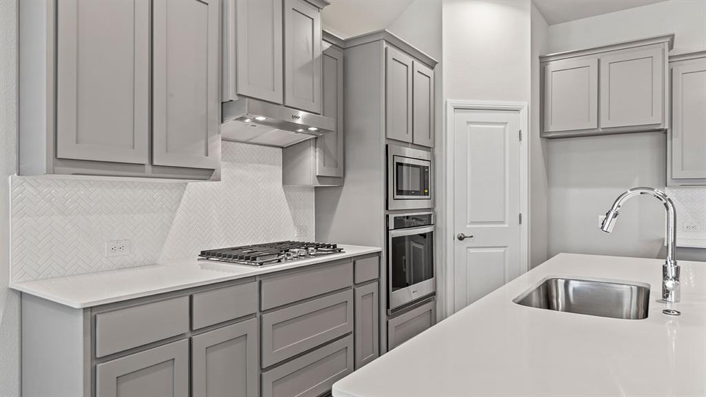 729 Soaring Hawk Drive Aledo, TX 76008 - Photo 3 of 38 a kitchen with cabinets and appliances