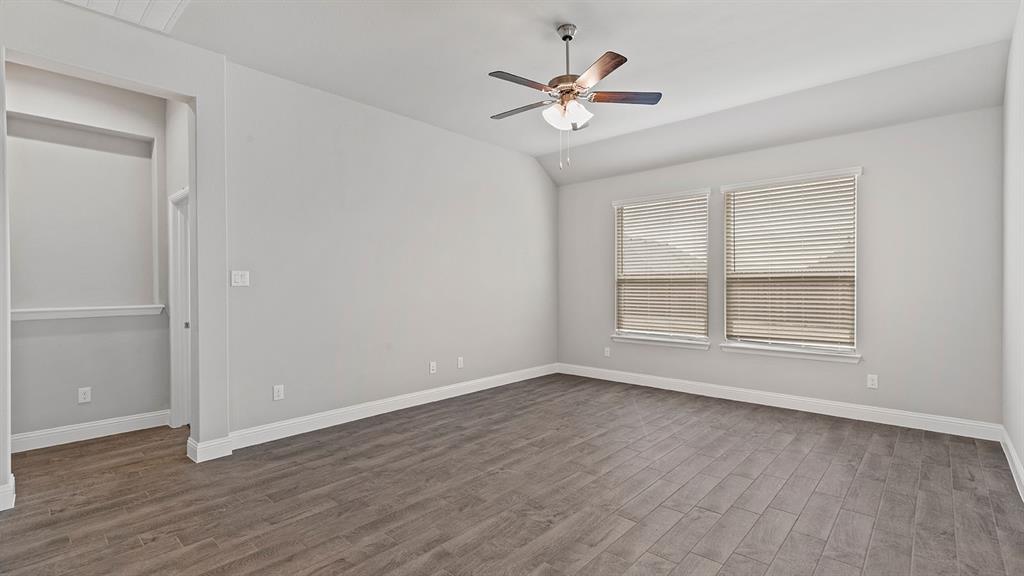 729 Soaring Hawk Drive Aledo, TX 76008 - Photo 7 of 38 a view of an empty room with a window and wooden floor
