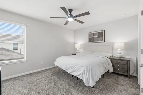 a bed room with a bed and a window