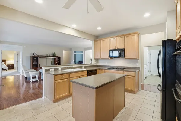 a kitchen with a sink a counter top space and stainless steel appliances