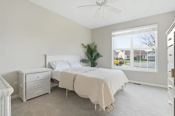 a bedroom with bed and window