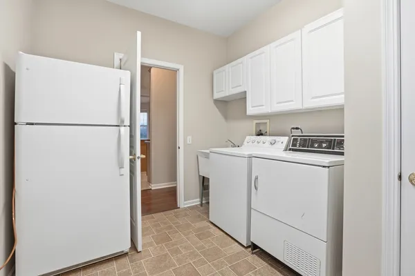 a utility room with refrigerator a washer and dryer