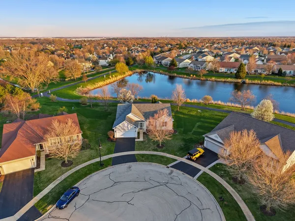 an aerial view of a house with a lake view