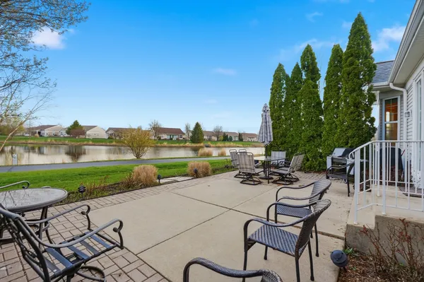 a view of a chairs and table in patio with a yard