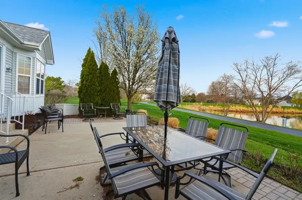 a view of a patio with a table and chairs