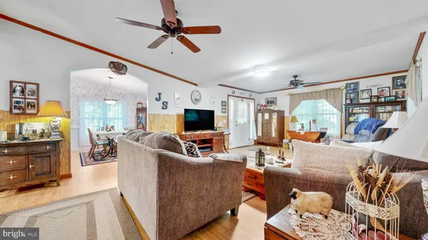 a living room with furniture and a chandelier