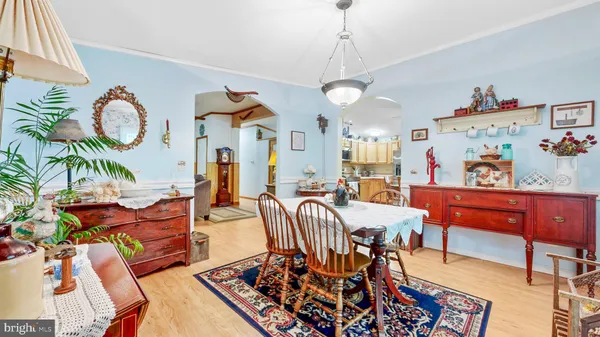 a view of a dining room with furniture and chandelier
