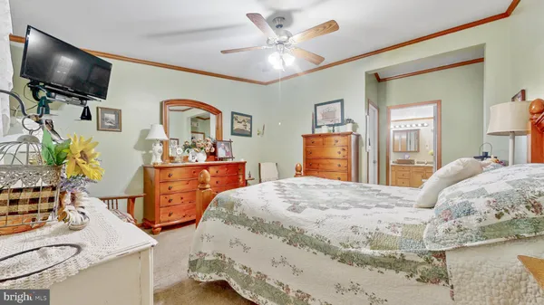 a bed room with a bed mirror and a window
