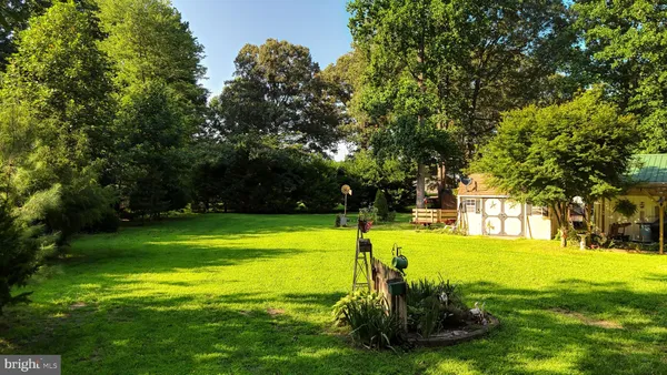 a view of a backyard with wooden fence