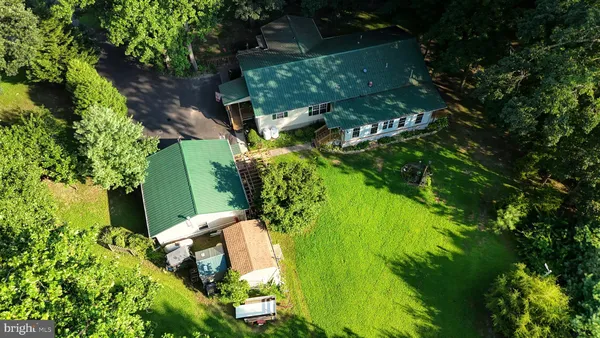 a front view of a house with yard and green space