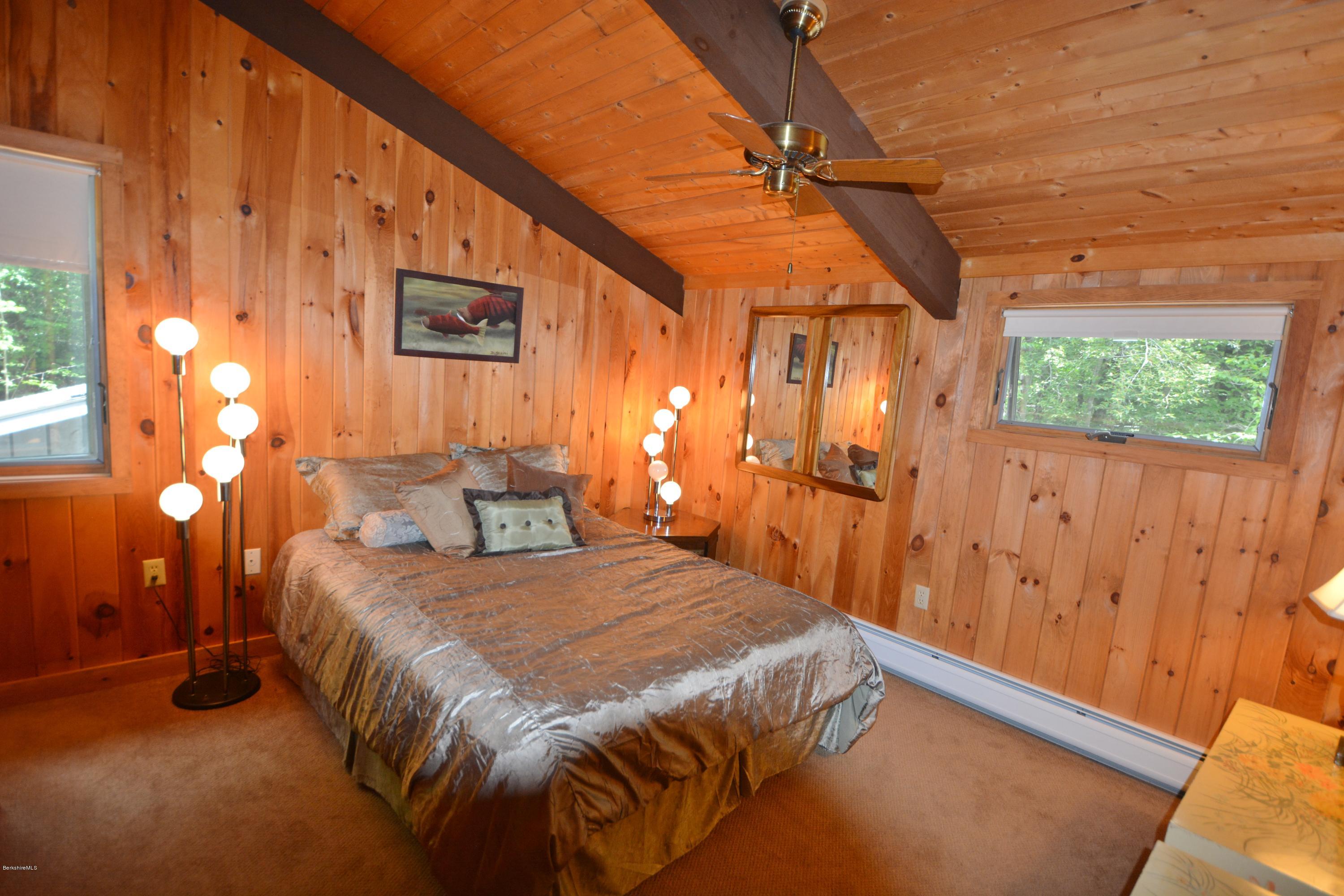 862 Moberg Road Becket, MA 01223 - Photo 14 of 26 a bedroom with a bed and a chandelier